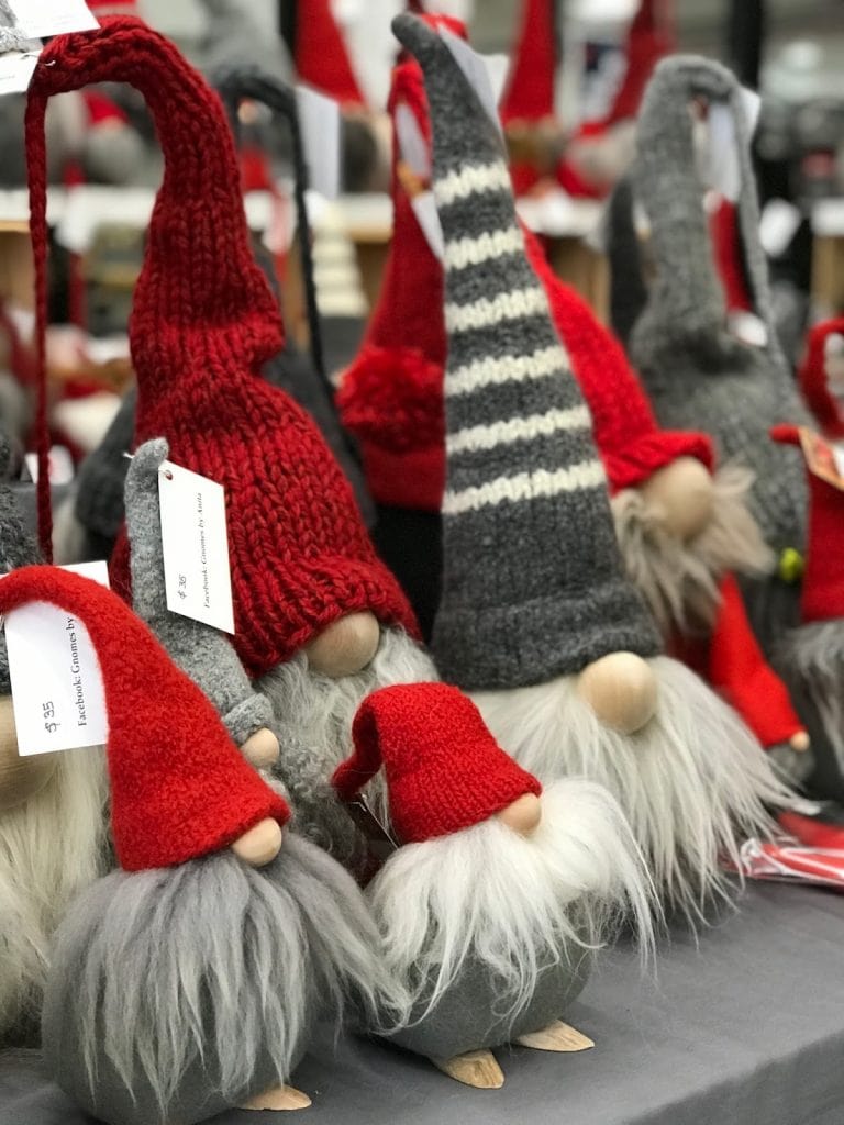 Plush gnomes with red and gray hats. Only their beards and noses can be seen peeking from beneath their hats