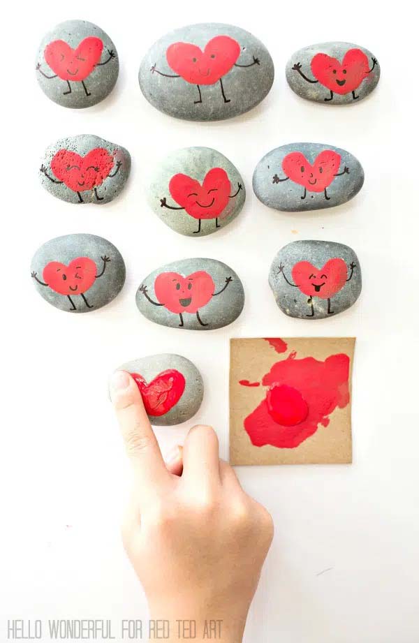 Friendship rock art craft with fingerprints and red paint