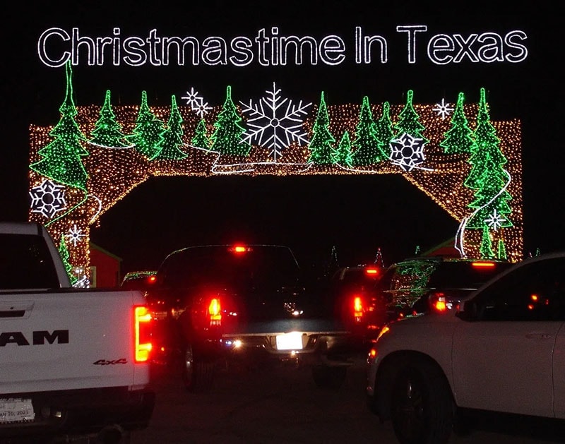 A lighted archway featuring several small christmas tree illustrations and title Christmastime in Texas