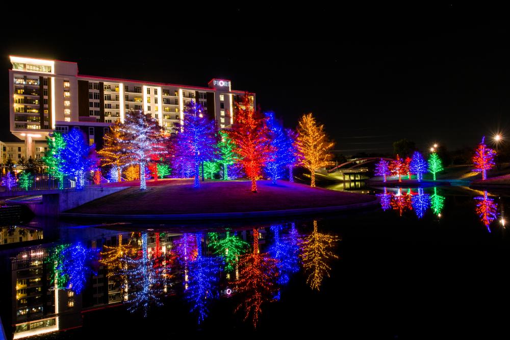 Christmas trees fully lit with a variety of colors in Addison at Vituvian Park