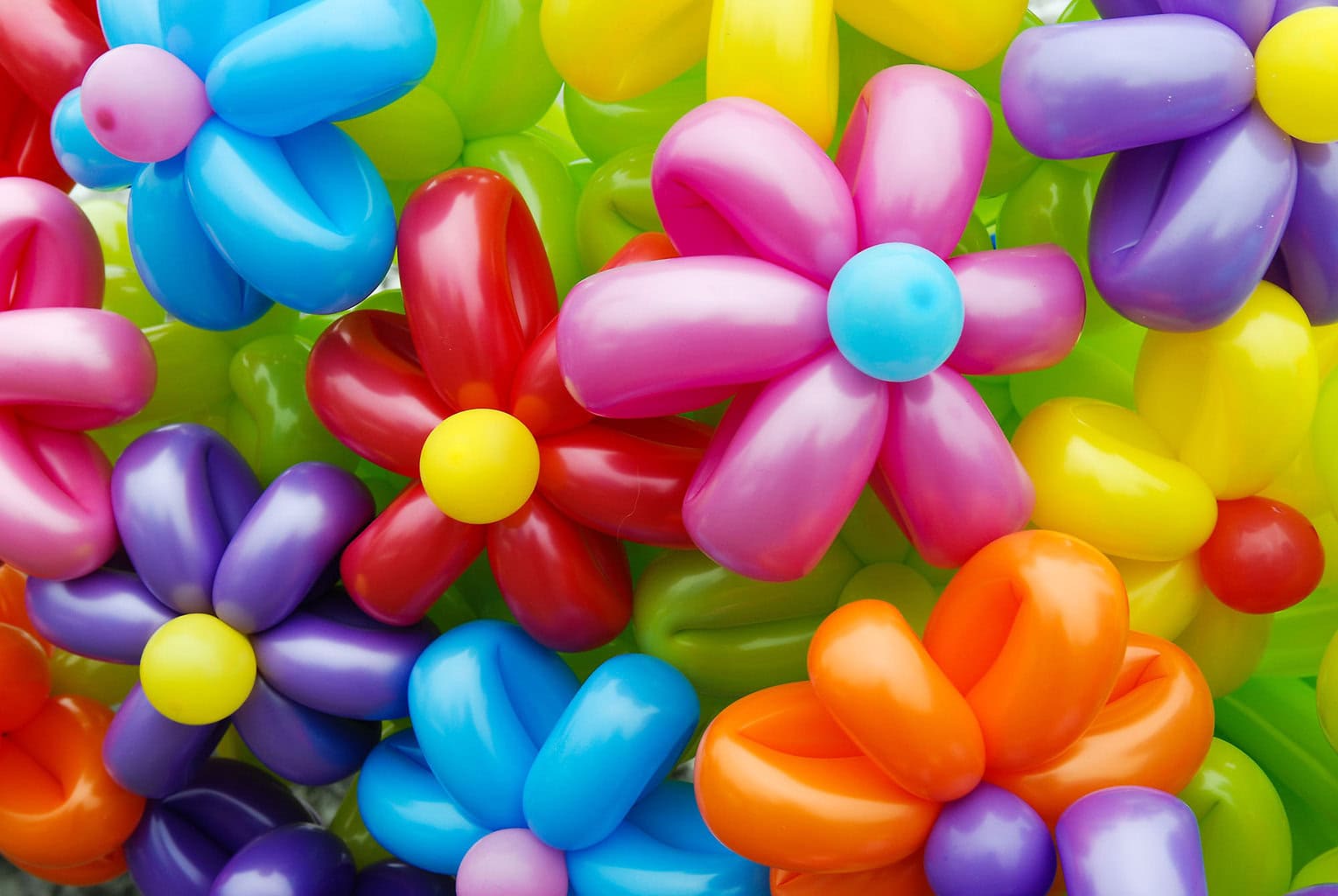 a large bouquet of balloon flowers all colors of the rainbow