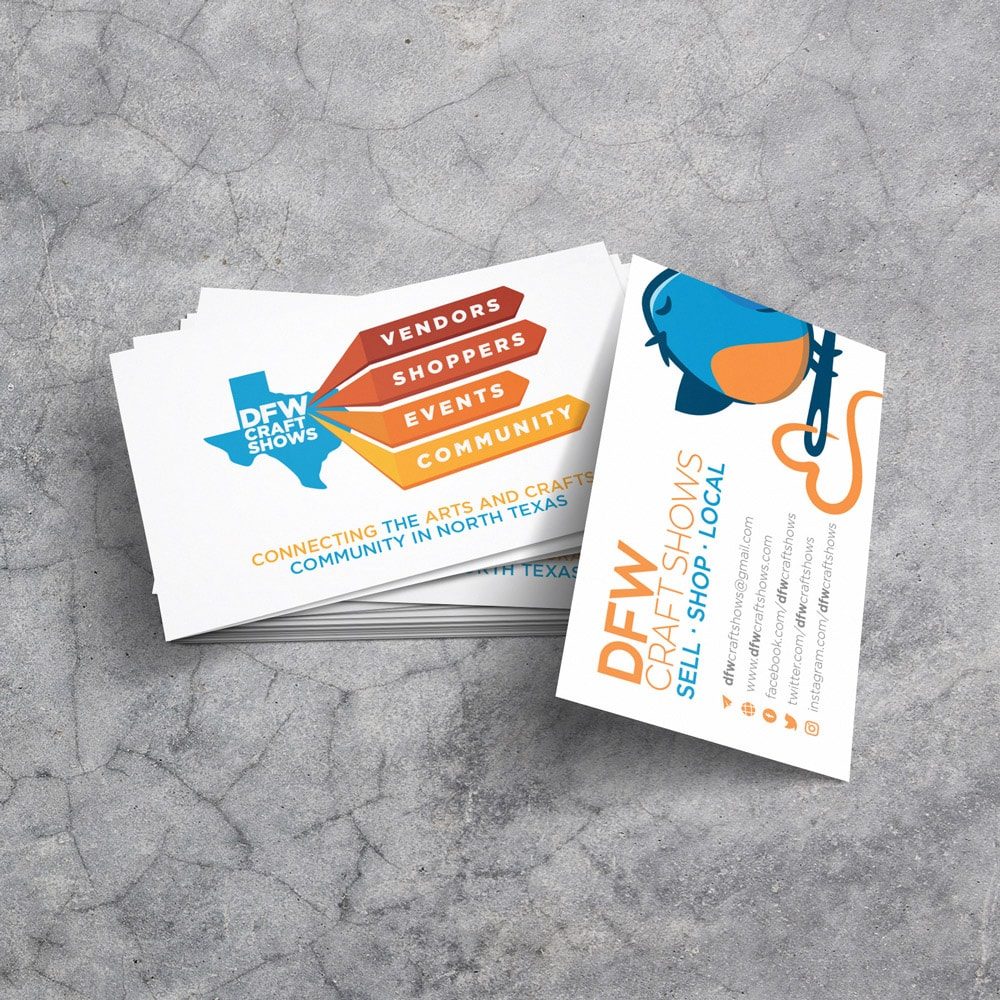 A stack of professionally designed business cards sits on a marble background. The front and back of the cards are both visible showing information about DFW Craft Shows.